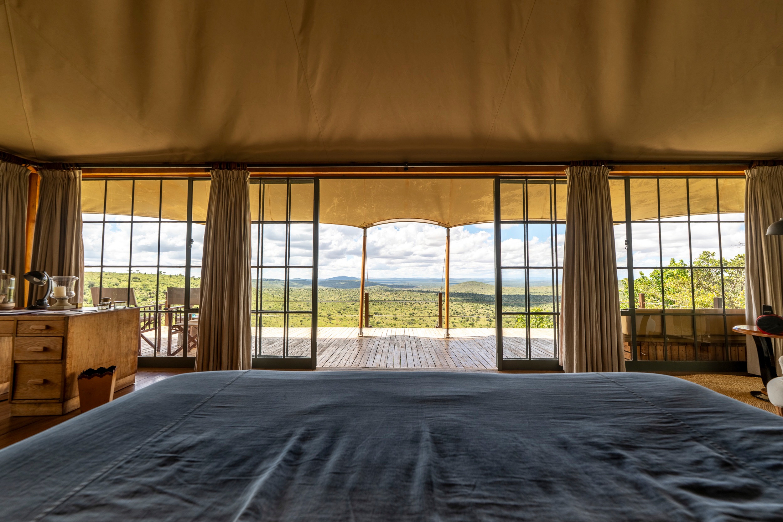 A tent room with a bed and a view over Loisaba, Elewana Loisaba Tented Camp