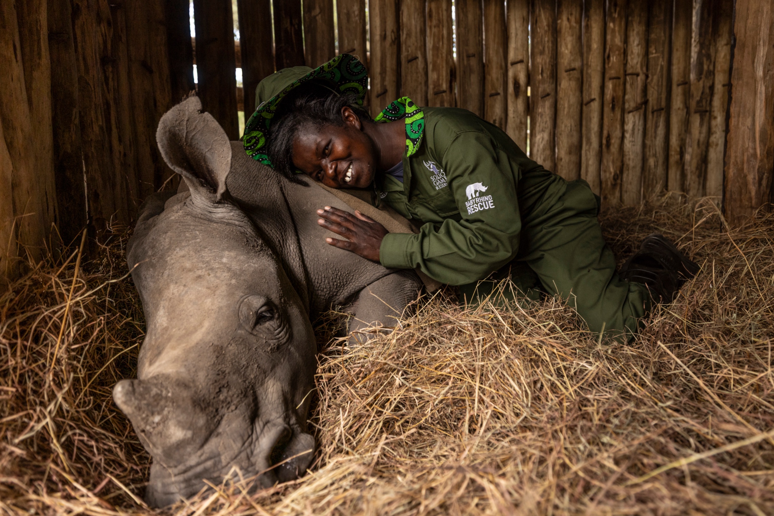 Malaika with a carer at Solio Rhino Orphanage, Solio Game Reserve